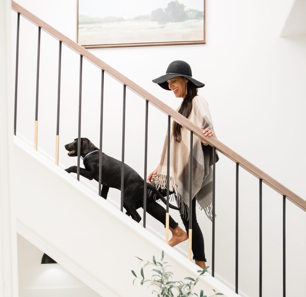 Dog with lady going up a set of modern staircase, modern staircase featuring a dog house under the stairs